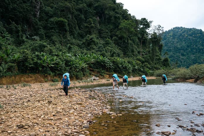 Porter team carry rice husk packages across jungles and rivers