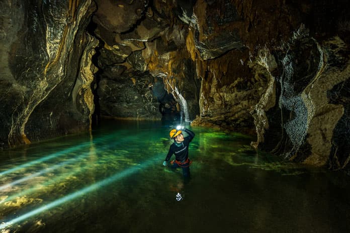The underground river inside Hang Va is crystal-clear and pleasantly cool